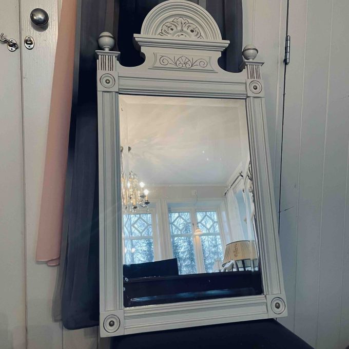 Vacker trässpegel med fasetterat glas